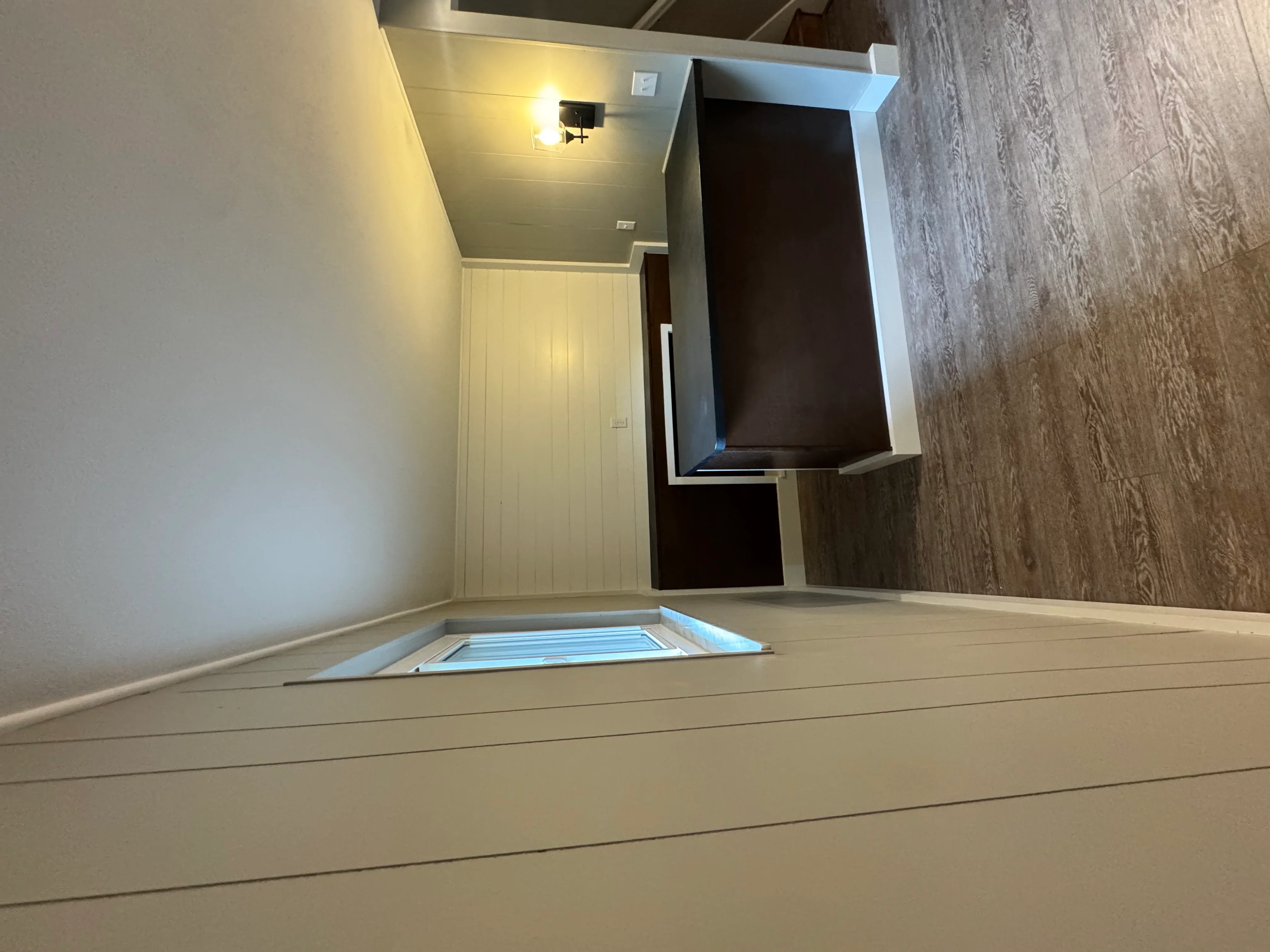 Finished attic bedroom with skylight, recessed lighting, and light wood flooring