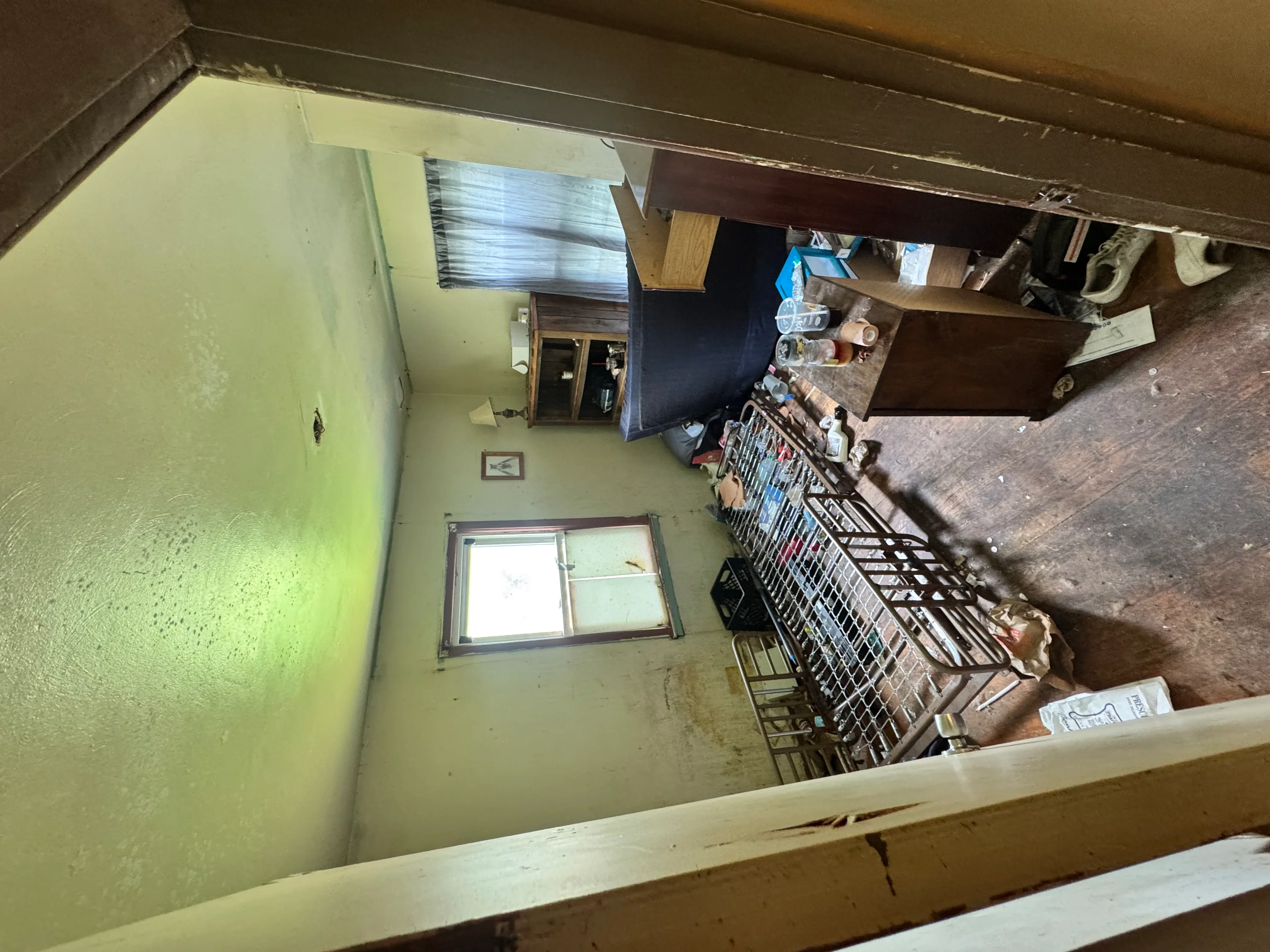Interior demolition project showing exposed framing, removed drywall, and cleared residential space
