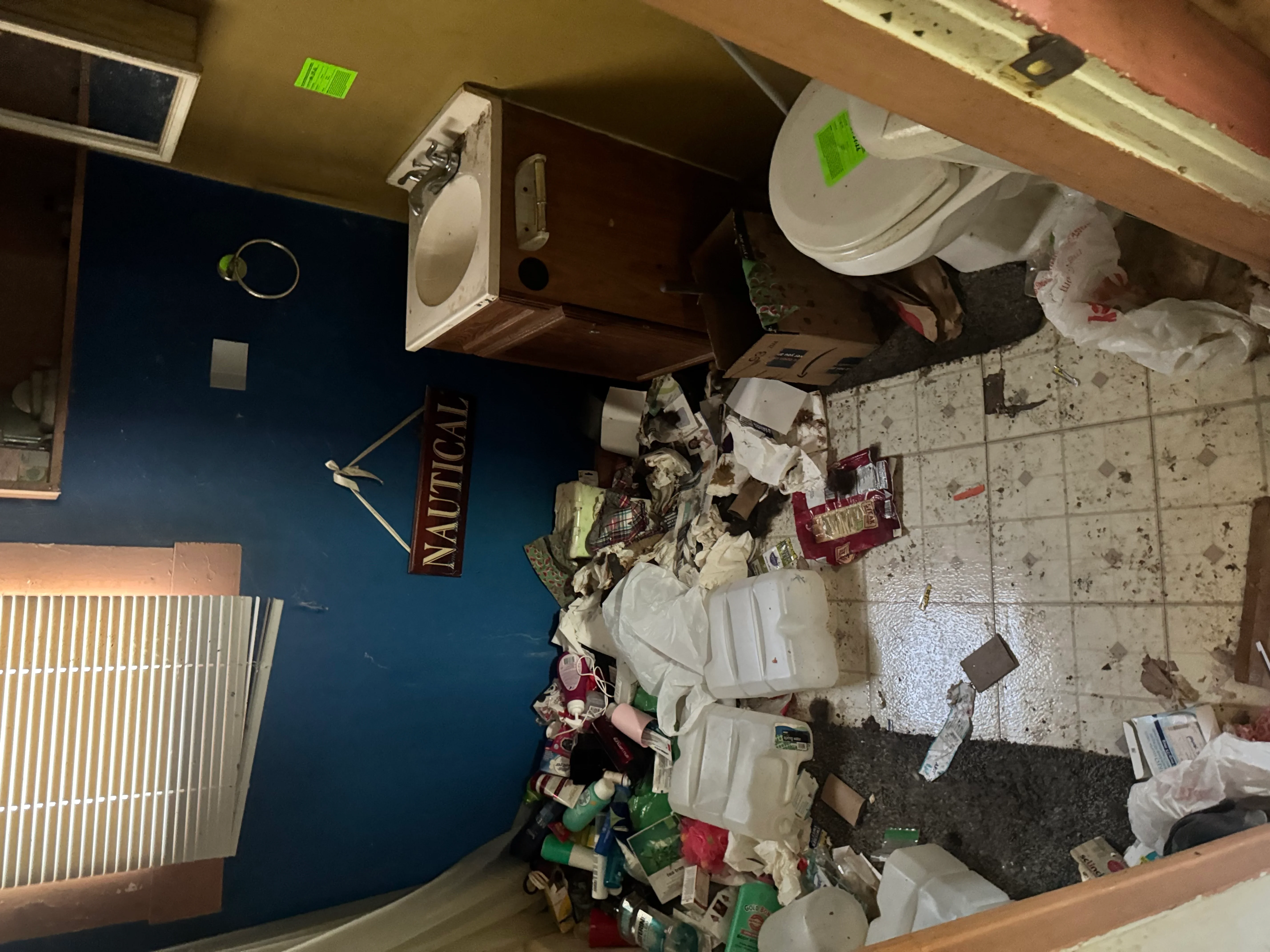 Commercial space demolition showing cleared walls, removed fixtures, and debris removal in progress