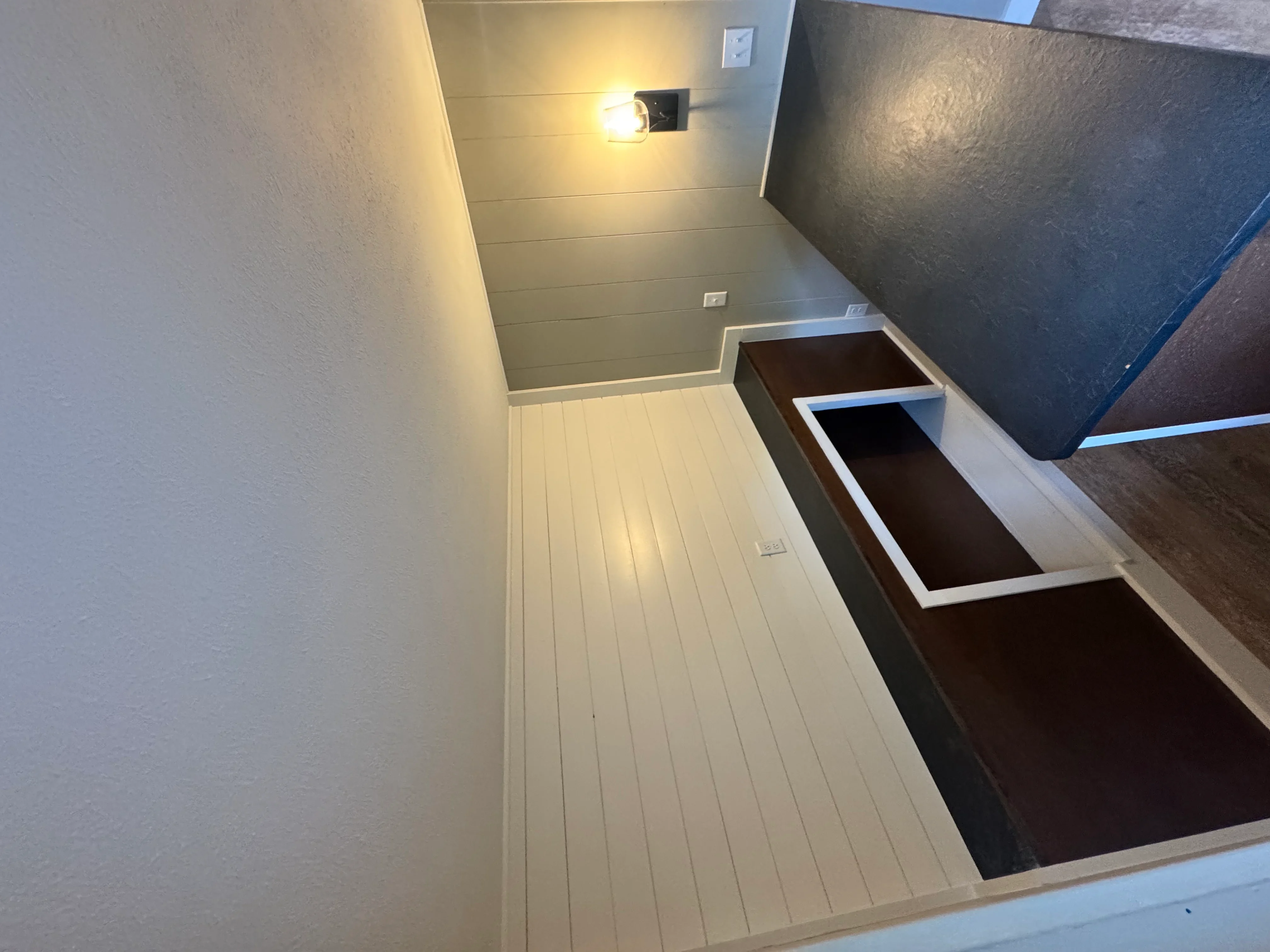 Finished basement with shiplap walls, recessed lighting, and built-in storage benches