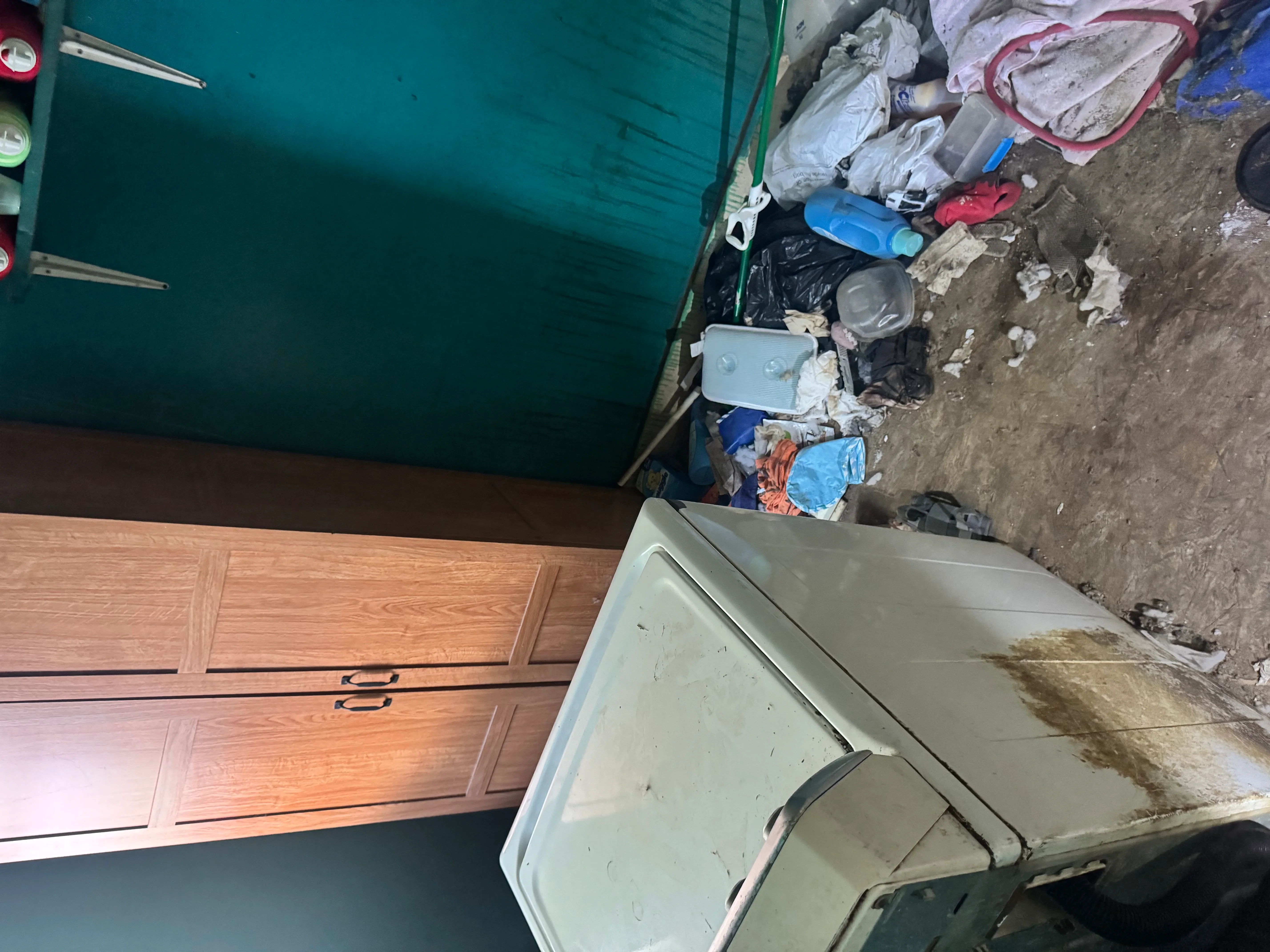 Residential junk removal project showing cleared debris and appliances ready for disposal