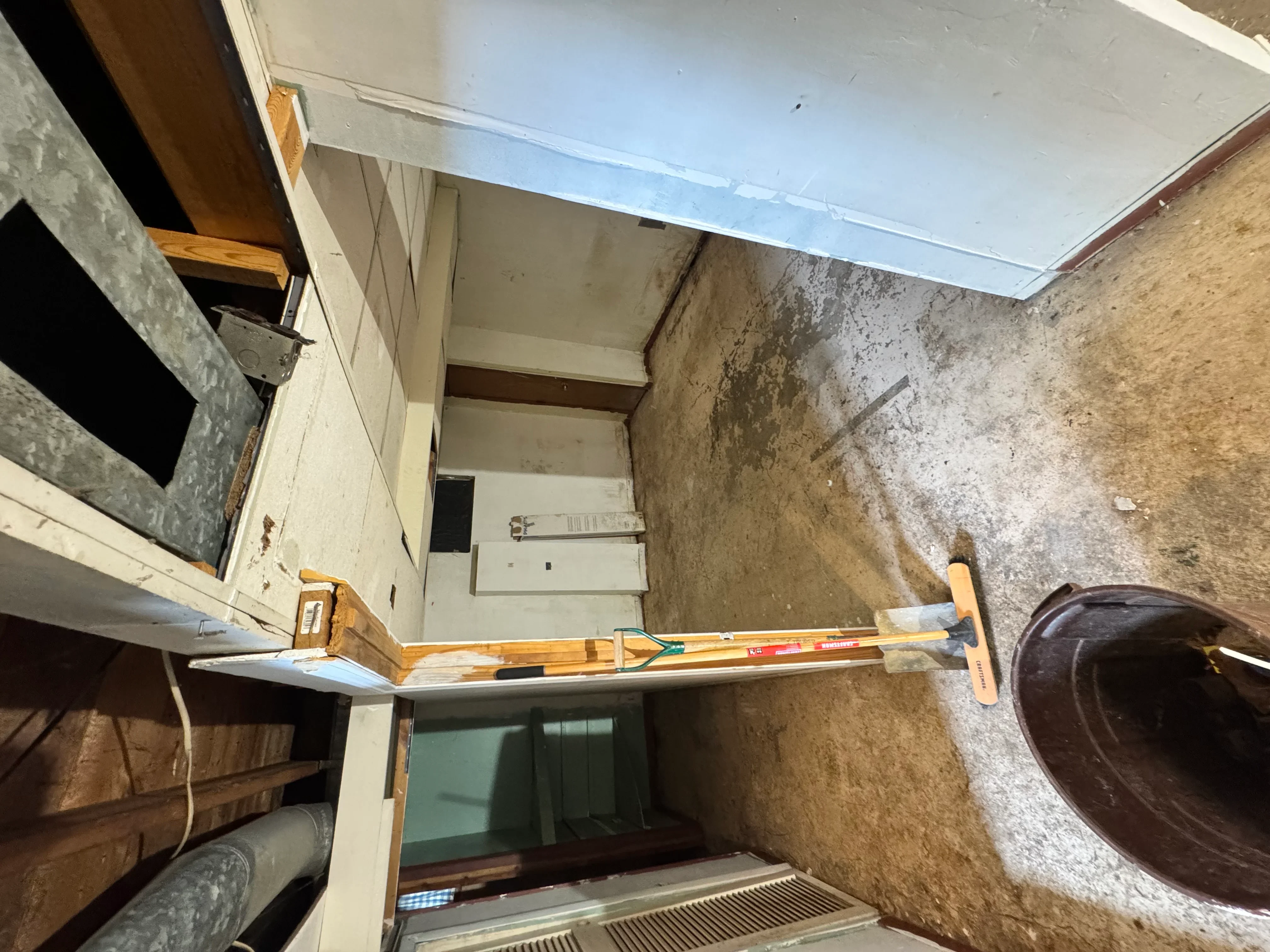 Interior demolition project showing exposed brick walls and cleared residential space