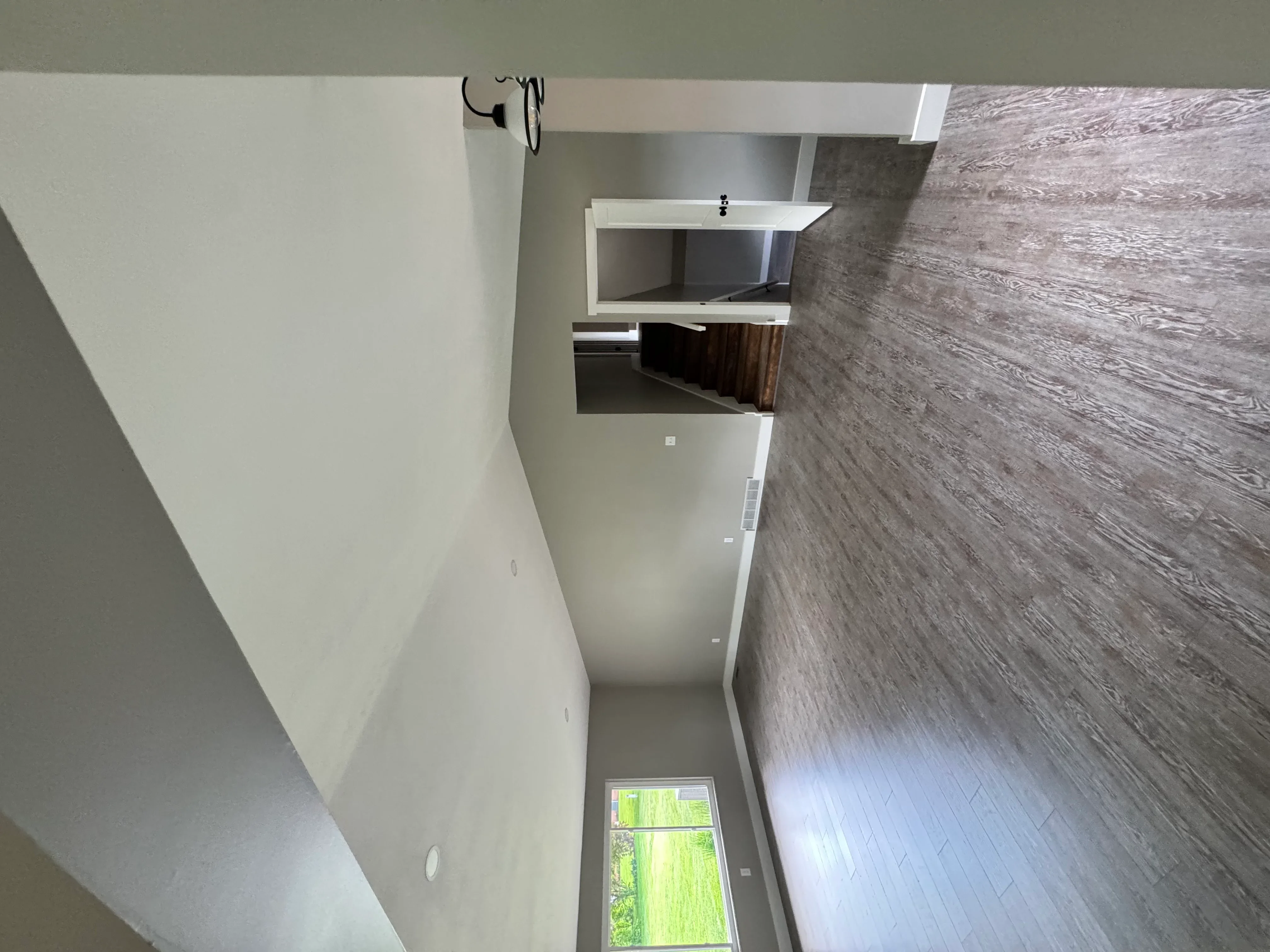 Modern bathroom with white walls, floating shelves, and gray wood-look tile flooring