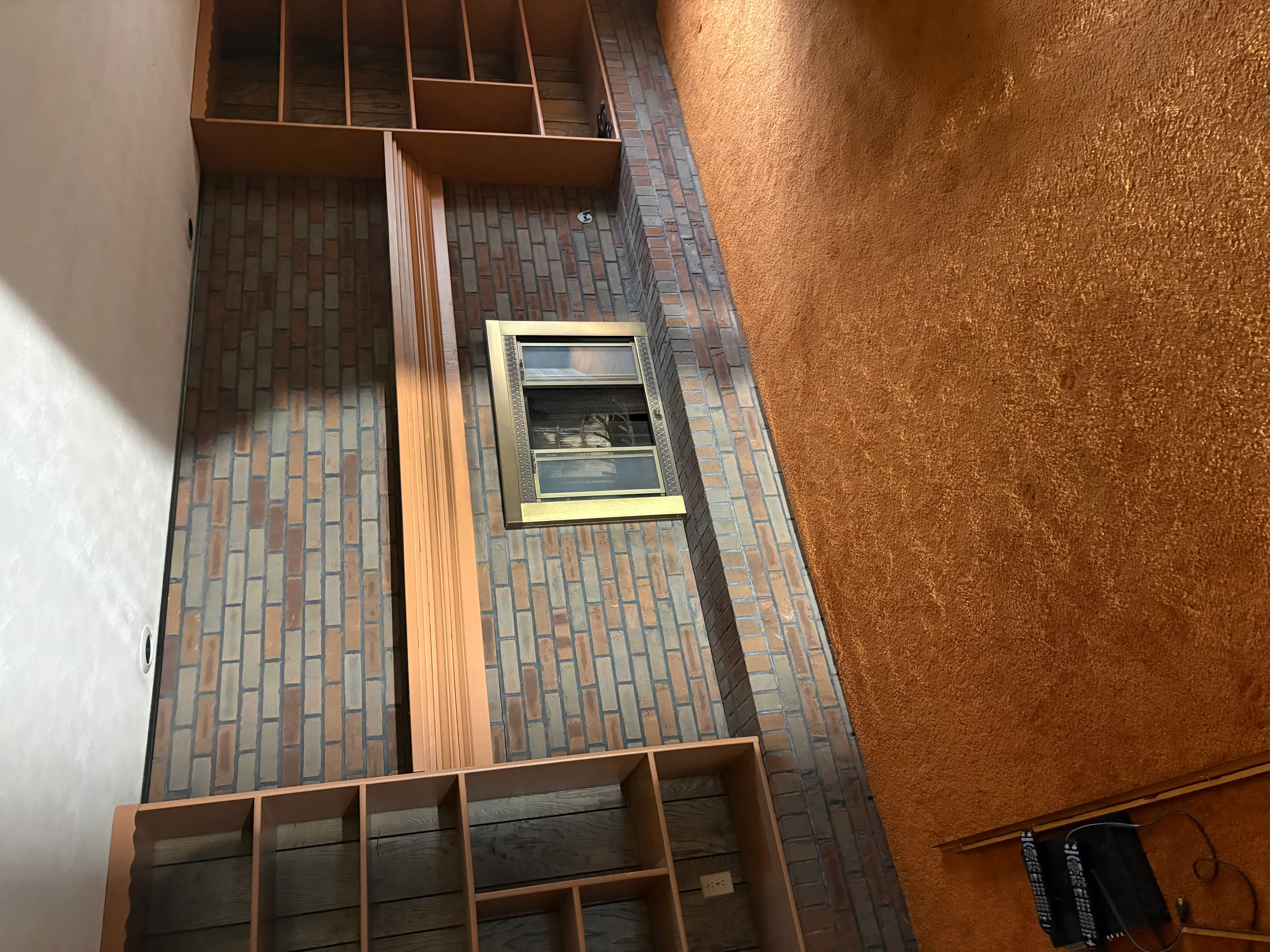 Interior brick veneer wall with wood trim framing and installed window in Dayton home